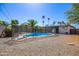 Swimming pool is fenced for safety, surrounded by mature trees providing shade and privacy at 1334 W Sells Dr, Phoenix, AZ 85013