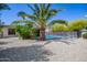 Sparkling in-ground pool surrounded by desert landscaping and protective safety fence at 1334 W Sells Dr, Phoenix, AZ 85013
