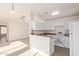 Kitchen with white cabinets and breakfast bar overlooking the living area at 13521 E Butler St, Chandler, AZ 85225