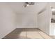 Open living room with ceiling fan and light wood-look flooring at 13521 E Butler St, Chandler, AZ 85225