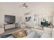 Bright living room with ceiling fan, open floor plan, and neutral decor at 13521 E Butler St, Chandler, AZ 85225