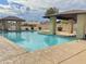 Community pool area with pristine blue water and covered seating at 13521 E Butler St, Chandler, AZ 85225