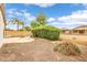 Spacious backyard with desert landscaping, a fire pit, a dining set, and block wall fencing at 1375 W Belmont Red Trl, San Tan Valley, AZ 85143