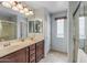 Bathroom featuring dual sinks, and tiled walk-in shower at 1375 W Belmont Red Trl, San Tan Valley, AZ 85143