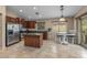 Modern kitchen with stainless steel appliances, an island, and an adjacent dining area at 1375 W Belmont Red Trl, San Tan Valley, AZ 85143