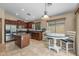 Well-lit kitchen with stainless steel appliances, center island, and adjacent breakfast nook at 1375 W Belmont Red Trl, San Tan Valley, AZ 85143
