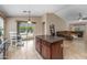 Open floor plan with tile flooring, kitchen island, view of backyard, and comfortable living area at 1375 W Belmont Red Trl, San Tan Valley, AZ 85143