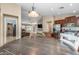 Open layout showcasing kitchen, dining area, and living room with large TV at 1375 W Belmont Red Trl, San Tan Valley, AZ 85143