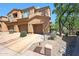 Exterior view of the tan townhomes featuring a two-car garage at 16600 N Thompson Peak Pkwy # 2006, Scottsdale, AZ 85260