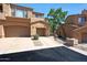 Exterior view of the tan, multi-level home with a two-car garage at 16600 N Thompson Peak Pkwy # 2006, Scottsdale, AZ 85260