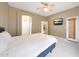 Spacious bedroom featuring neutral walls, carpet flooring, ceiling fan and door to patio at 16600 N Thompson Peak Pkwy # 2006, Scottsdale, AZ 85260