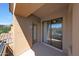 Comfortable covered patio with mountain views, glass door, and cool outdoor ceiling fan at 16600 N Thompson Peak Pkwy # 2006, Scottsdale, AZ 85260