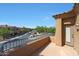 Private patio with wrought iron railing offers views of a neatly landscaped neighborhood with mature trees at 16600 N Thompson Peak Pkwy # 2006, Scottsdale, AZ 85260