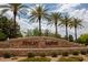 The Finley Farms entrance is beautifully landscaped with a stone wall, green plants, and a variety of trees at 1894 E Sagebrush St, Gilbert, AZ 85296