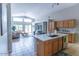 Open kitchen with an island, sleek countertops, and access to a dining and living area at 1894 E Sagebrush St, Gilbert, AZ 85296