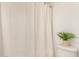 Bright bathroom featuring a patterned shower curtain and charming plant accent at 2035 S Elm St # 211, Tempe, AZ 85282