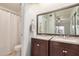 Bathroom features dual sink vanity with cabinets, granite countertops, and tiled flooring at 2035 S Elm St # 211, Tempe, AZ 85282