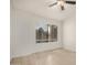 This bedroom has a ceiling fan, a window, and wood-look laminate flooring at 2035 S Elm St # 211, Tempe, AZ 85282