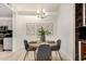 Cozy dining area with a round table, modern chandelier, and adjacent to the kitchen area at 2035 S Elm St # 211, Tempe, AZ 85282