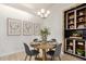 Modern dining area featuring a round table, stylish chairs, and built-in shelving at 2035 S Elm St # 211, Tempe, AZ 85282