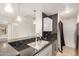 Contemporary kitchen with dark countertops, stainless steel appliances, and an open view to other rooms at 2035 S Elm St # 211, Tempe, AZ 85282