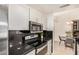 Modern kitchen featuring stainless steel appliances, sleek cabinetry, and an adjoining dining area at 2035 S Elm St # 211, Tempe, AZ 85282
