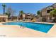 Sparkling community pool with clear blue water, lounge area, and nearby buildings at 2035 S Elm St # 211, Tempe, AZ 85282