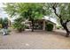 Spacious backyard with desert landscaping, covered patio, and shade trees, perfect for outdoor living at 20669 N 266Th Ave, Buckeye, AZ 85396