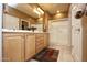 Spacious bathroom with double sinks, a large mirror, and a walk-in shower at 20669 N 266Th Ave, Buckeye, AZ 85396