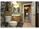 Bathroom with vanity, mirror, and toilet; hallway visible in the background at 20669 N 266Th Ave, Buckeye, AZ 85396