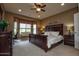 Comfortable bedroom showcasing a ceiling fan and a large window with seating at 20669 N 266Th Ave, Buckeye, AZ 85396