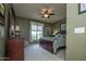 Comfortable bedroom with a ceiling fan, window, and stylish furnishings at 20669 N 266Th Ave, Buckeye, AZ 85396