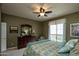 Bedroom with dresser, ceiling fan, and a window providing natural light at 20669 N 266Th Ave, Buckeye, AZ 85396