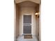 Close-up of the front door with a screen door and welcome mat at 20669 N 266Th Ave, Buckeye, AZ 85396