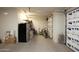 Well-lit garage with additional refrigerator, shelving, and bike storage, offering extra utility at 20669 N 266Th Ave, Buckeye, AZ 85396