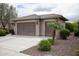 Attached two-car garage with brown doors and well-maintained landscaping at 20669 N 266Th Ave, Buckeye, AZ 85396