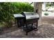 Outdoor kitchen featuring a charcoal grill on a brick paver patio, perfect for outdoor cooking at 20669 N 266Th Ave, Buckeye, AZ 85396