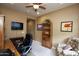 Comfortable home office with a desk, shelves, and a cozy chair in a well-lit space at 20669 N 266Th Ave, Buckeye, AZ 85396