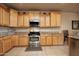 Well-equipped kitchen with wooden cabinets and stainless steel appliances at 20669 N 266Th Ave, Buckeye, AZ 85396