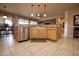 Bright kitchen featuring granite countertops, stainless steel dishwasher, and wooden cabinets at 20669 N 266Th Ave, Buckeye, AZ 85396