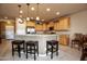 Gourmet kitchen featuring granite countertops, bar seating, and stainless steel appliances at 20669 N 266Th Ave, Buckeye, AZ 85396