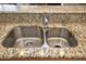 Close-up of a stainless steel, double-basin kitchen sink with granite countertop at 20669 N 266Th Ave, Buckeye, AZ 85396