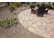 Wide view of brick paver patio surrounded by desert landscaping, including cactus and gravel at 20669 N 266Th Ave, Buckeye, AZ 85396