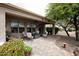 Outdoor patio featuring brick pavers, patio furniture, grill, and beautiful desert landscaping at 20669 N 266Th Ave, Buckeye, AZ 85396