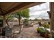 Covered patio features brick pavers and desert landscaping, perfect for enjoying the outdoors at 20669 N 266Th Ave, Buckeye, AZ 85396