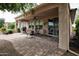 Covered outdoor patio with brick pavers, patio furniture, and a grill, perfect for relaxing and entertaining at 20669 N 266Th Ave, Buckeye, AZ 85396