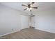 Neutral bedroom featuring a ceiling fan, wood-look flooring, closet and access to the hallway at 2502 S Mollera Cir, Mesa, AZ 85210