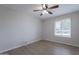 Minimalist bedroom featuring a window and wood-look flooring at 2502 S Mollera Cir, Mesa, AZ 85210