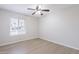 Bright bedroom with a window and wood-look tile flooring at 2502 S Mollera Cir, Mesa, AZ 85210