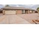 Charming single-story home features a brick exterior and a two-car garage and neutral gravel landscaping at 2502 S Mollera Cir, Mesa, AZ 85210